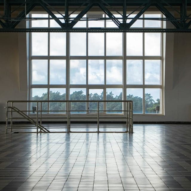 Dance studio rental room with wooden floor and window railing