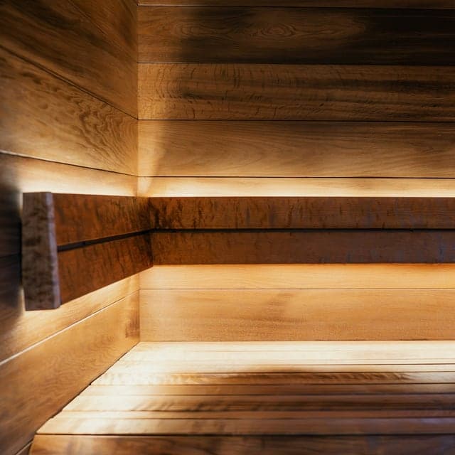 Warm wooden sauna interior with private session seating